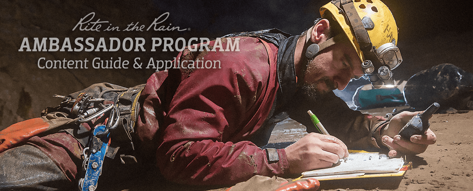 Man in muddy cave writing data on all weather loose leaf. 