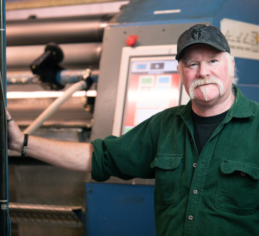 Coating Machine operator looking at camera.