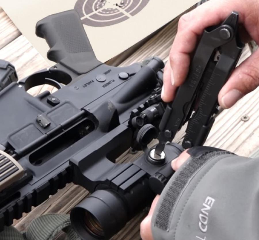 Ash adjusting his scope.