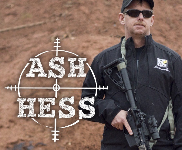 Master Marksmanship Trainer, Ash Hess standing near target.