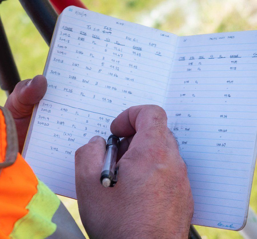 Jordan entering data into a staple all weather notebook.