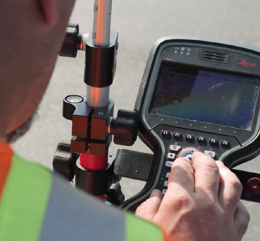 Jordan entering data into survey equipment.