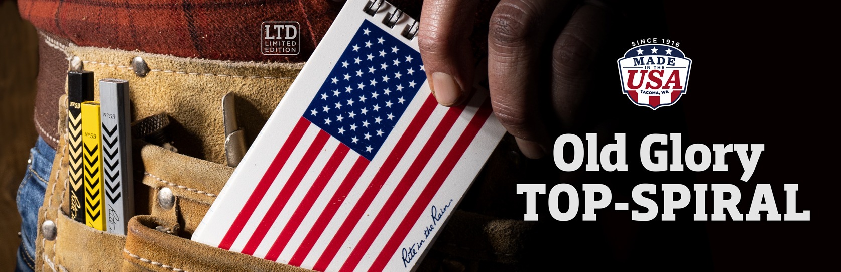 NEW Old Glory Top-Spiral Notebook being tucked into a toolbelt. Since 1916, Made in the USA.