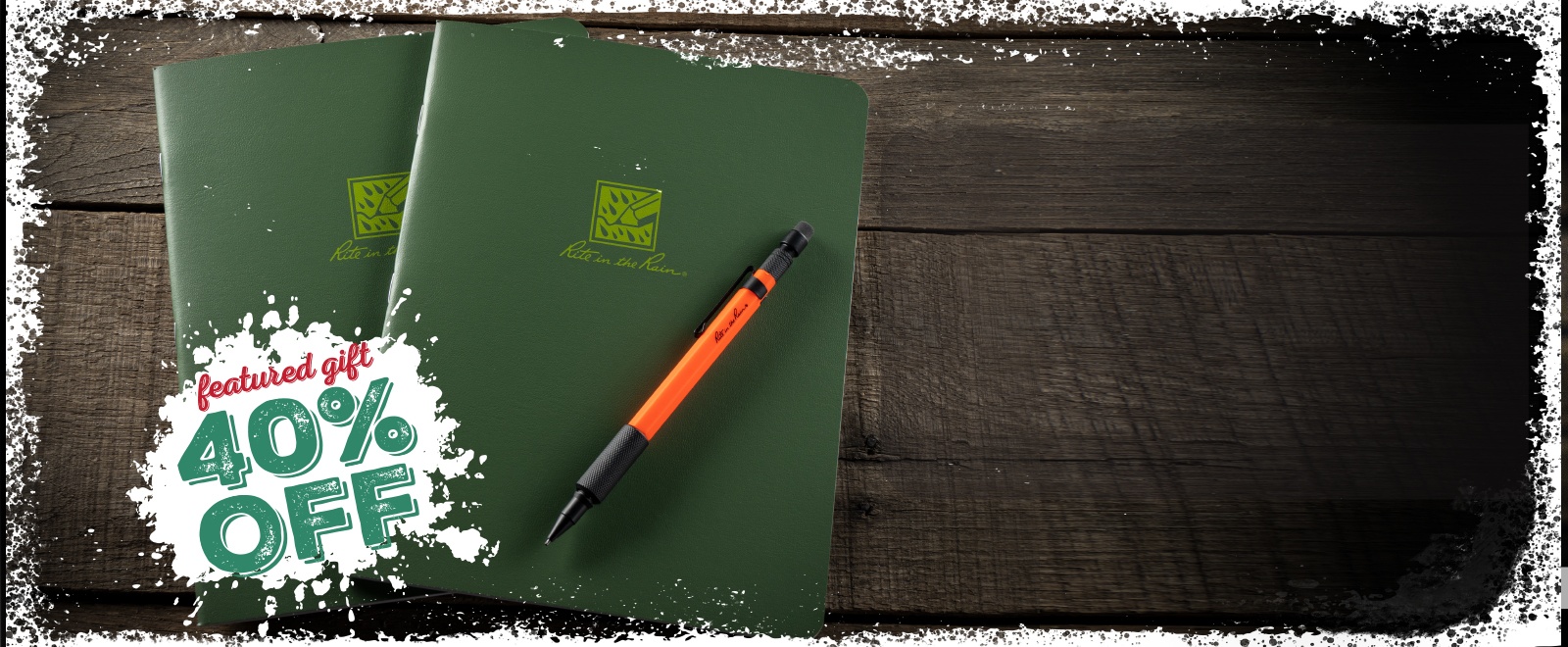 Two green all-weather notebooks and an orange mechanical pencil.