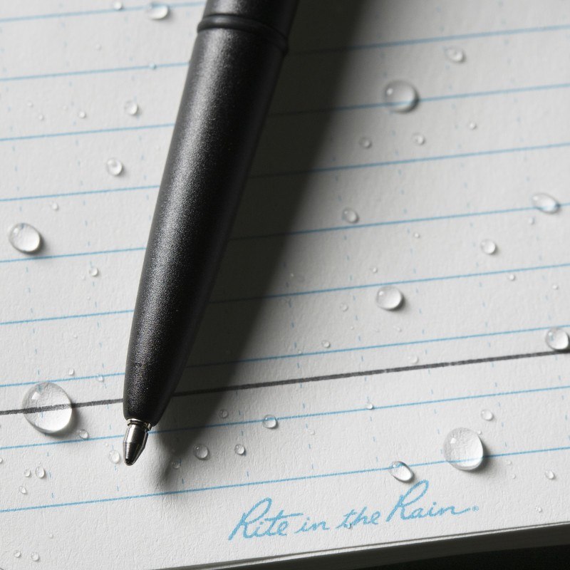 Metal weatherproof pen on wet paper, ink writing through water.