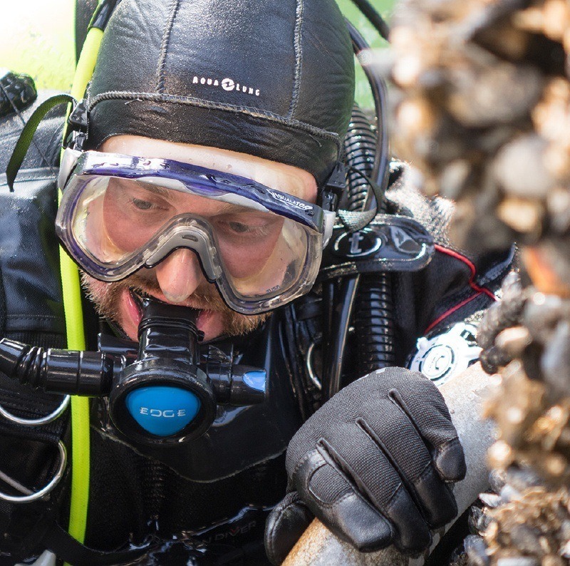 Vessel inspector under water.