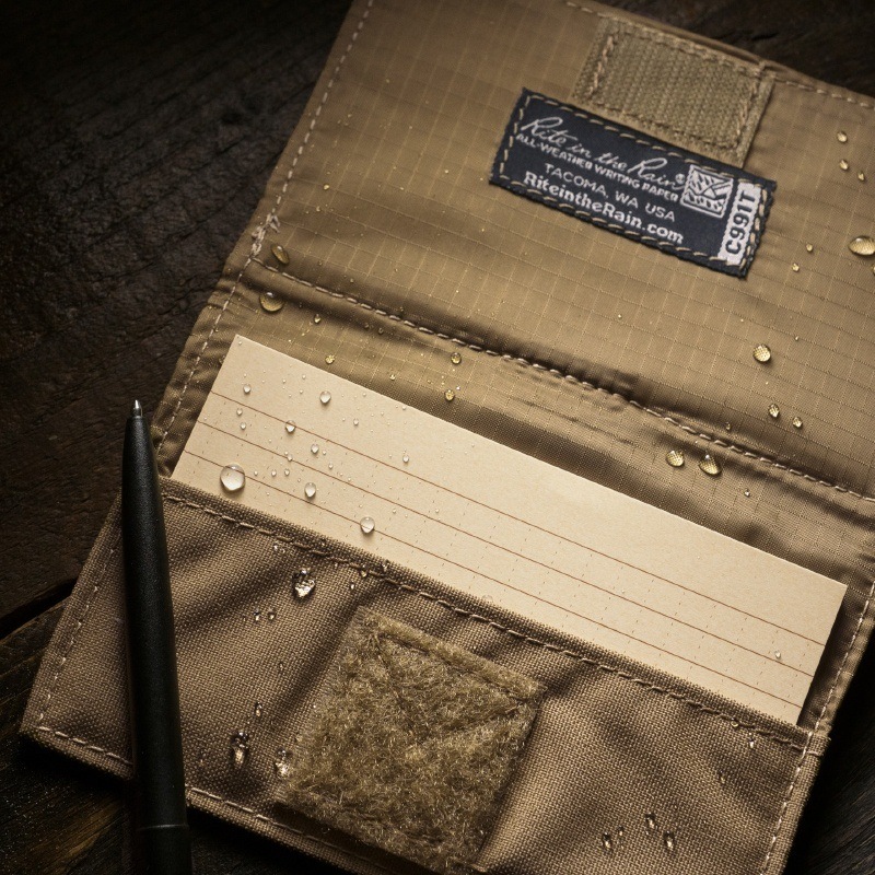 Index card wallet open with wet weatherproof index cards and all-wather pen.