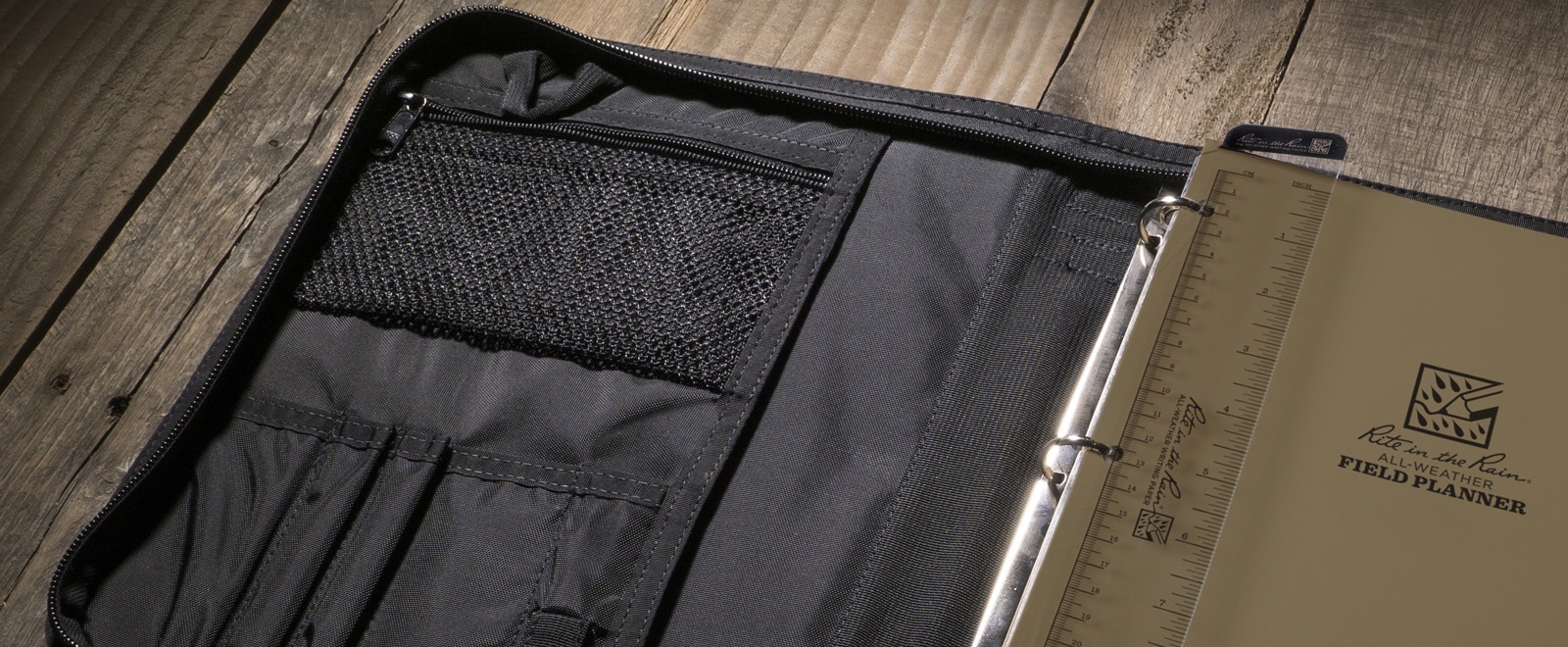 Open planner with ruler, writing guard, and ring binder.