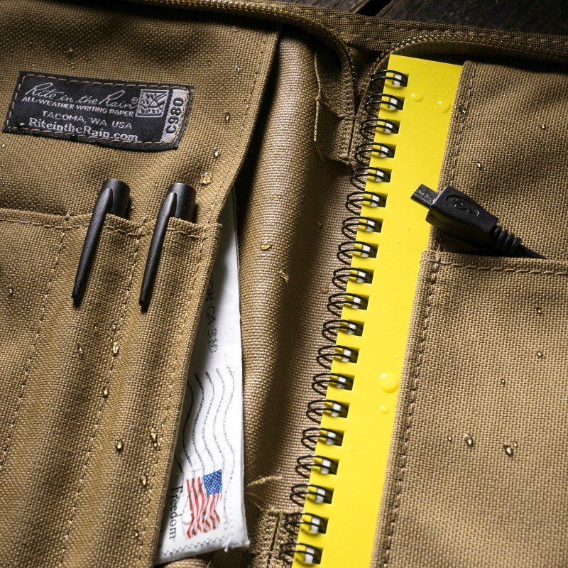 Side bound cover filled with pens and a notebook.