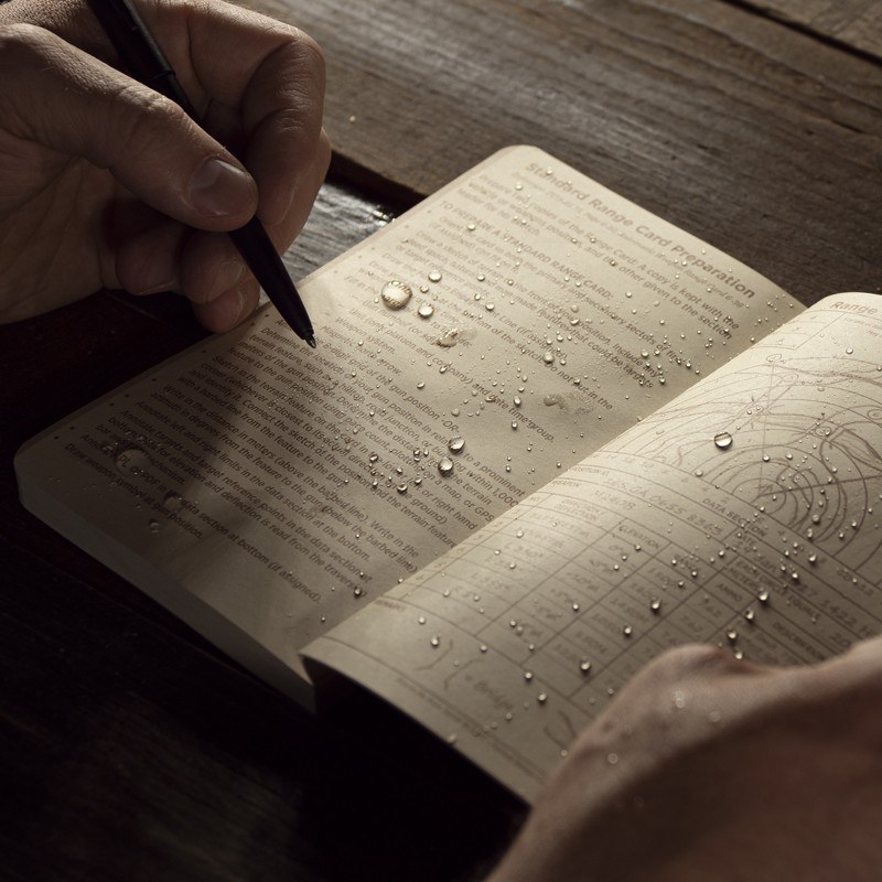All weather pen writing on wet open field book reference page.