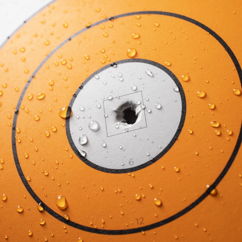 Close up of bullet hole through wet target.