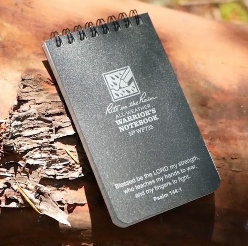 Notebook sitting on tree bark.